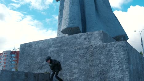 Seven-year-old-boy-climbs-of-the-pedestal-of-the-monument.-Parkour-in-town.