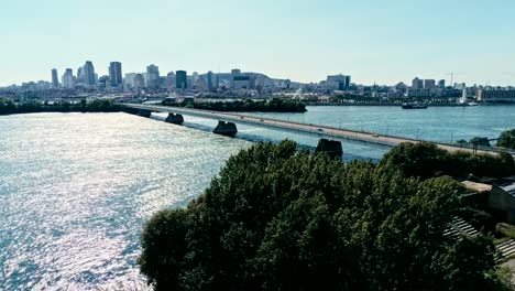 aerial-drone-footage-of-montreal-with-bridges-and-skyscrapers-in-the-background-on-the-horizon