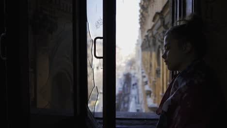 The-girl-is-standing-at-the-window.