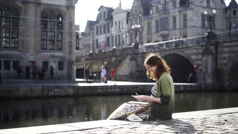 Woman-sitting-on-the-riverbanks.