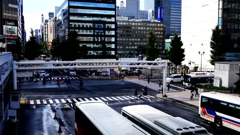 Wide-shot-of-people-walking-at-a-busy-cross-road-junction