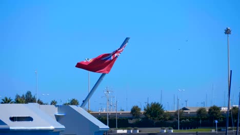 A-large-English-flag-mounted-on-the-stern-of-a-large-ship-fluttering-in-the-wind