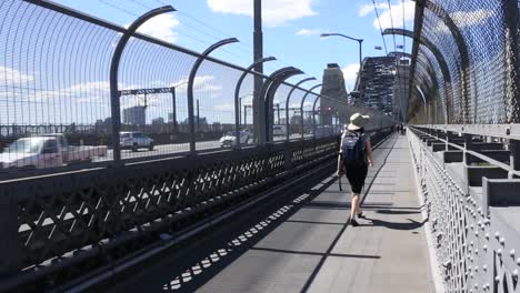 Person-crossing-Sydney-Harbor-Bridge-Australia