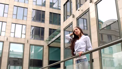 Girl-with-well-groomed-long-hair-stands-in-city.