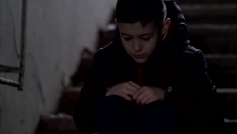 boy-sits-alone-in-an-old-ramshackle-building,-boy-regrets-the-incident,-demolition-house
