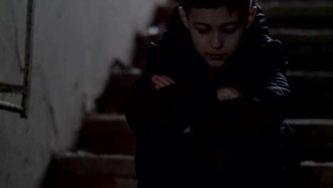 boy-sits-alone-in-an-old-ramshackle-demolition-house,-regrets-the-incident,-cold-weather