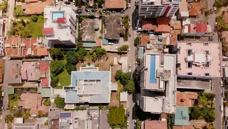 Drone-flying-right-above-Colombo-city-buildings,-Sri-Lanka.-Aerial-view-of-sunny-Asian-private-houses-and-modern-hotels