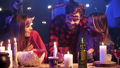 Man-in-costume-scaring-his-friends-at-halloween-party