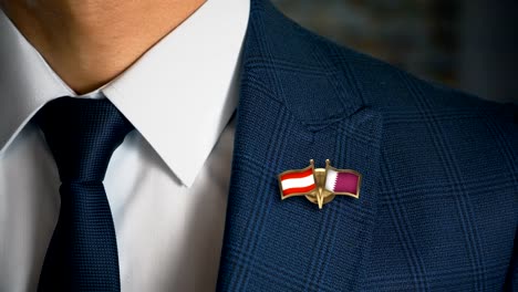 Businessman-Walking-Towards-Camera-With-Friend-Country-Flags-Pin-Austria---South-Korea