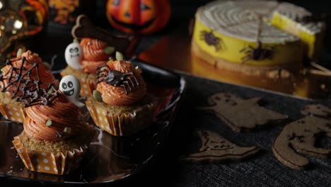 Fancy-Halloween-food-Party-Table-with-Pumpkin-Cupcake-Muffin-and-cookies.