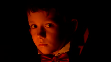 Boy-in-vampire-costume-posing-for-camera,-makeup-as-evil-spirits-on-Halloween