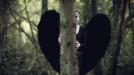 4k-Halloween-Dark-Angel-Woman-with-Black-Wings-in-Forest-Hidding