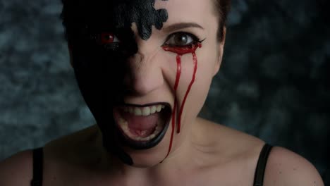 4k-Shot-of-a-Woman-with-Halloween-Make-up-With-Blood-tears,-screaming