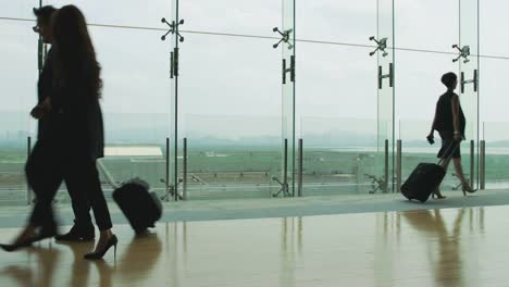 asian-businessman-and-businesswoman-walking-talking-in-airport