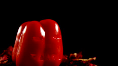 Halloween-red-pepper-against-black-background-4k