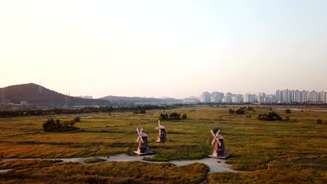 Aerial-Flying-next-to-wooden-windmill-at-Incheon-Sohrae-Ecological-Park,-South-Korea.Drone-Video