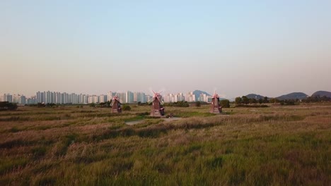 Aerial-Flying-next-to-wooden-windmill-at-Incheon-Sohrae-Ecological-Park,-South-Korea.Drone-Video