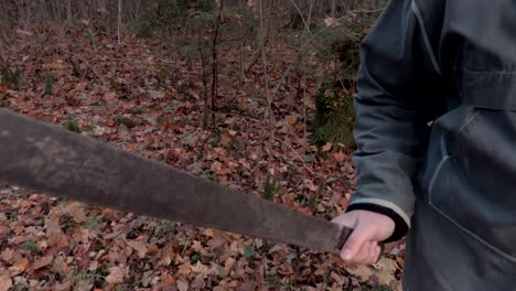 Camera-focusing-on-machete-then-on-man-in-scary-Halloween-mask