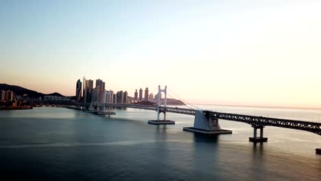 Gwangan-Bridge-and-Haeundae-aerial-view-at-Sunrise,-Busan,-South-Korea.