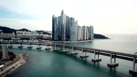 Gwangan-Bridge-and-Haeundae-aerial-view-at-Sunrise,-Busan,-South-Korea.