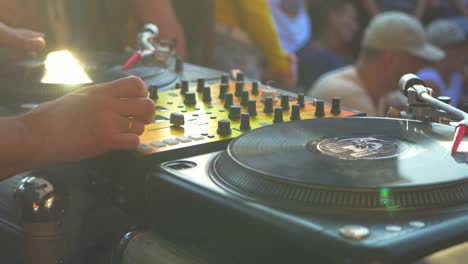 close-up-dj-hand-scratching-vinyl-record-on-turntable-on-a-party