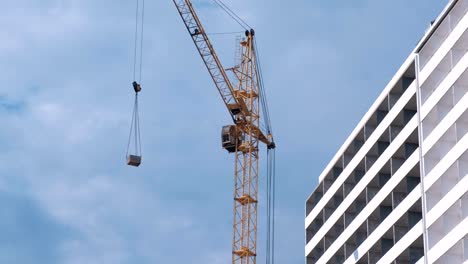 Construction-of-a-multi-storey-building.-House-and-construction-crane-on-sky-background.