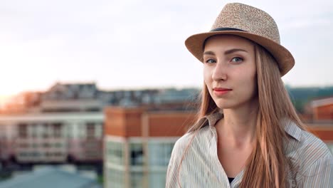 Portrait-of-shy-happy-European-female-traveler-smiling-and-playing-with-her-hair-outdoor