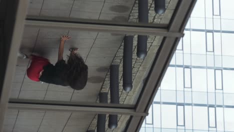 Glass-Reflection-of-a-Young-Woman-Dancing-on-Sidewalk