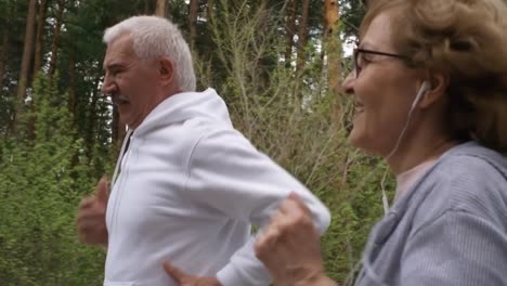 Senior-Woman-and-Man-Jogging-in-Forest