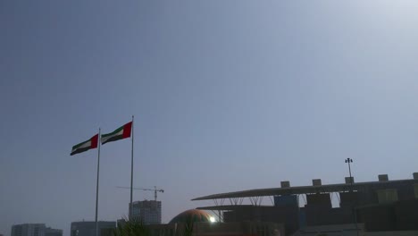 The-United-arab-emirates-flags-waving-in-Abu-Dhabi-city