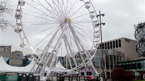 Wide-Shot-of-Ferris-Wheel-Cars-Spinning-Among-Christmas-Attractions-and-Lights