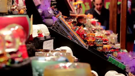 Shoppers-Buying-Gifts-at-German-Christmas-Market-Toy-Stall---Twinkling-Lights