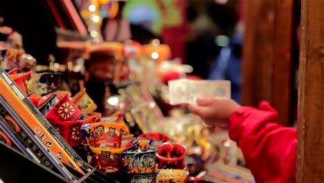 Shoppers-Exchange-Money-at-German-Christmas-Market-Toy-Stall---Twinkling-Lights