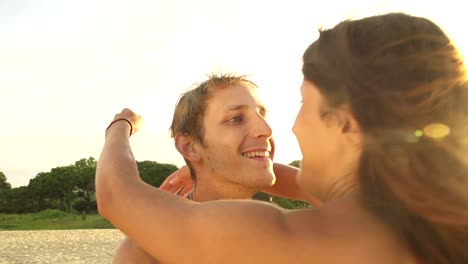 SLOW-MOTION:-Happy-young-couple-hugging-at-sunset