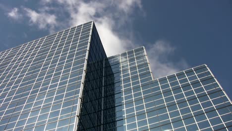 Blue-mirrored-office-tower.-Time-lapse-cloud-reflections.