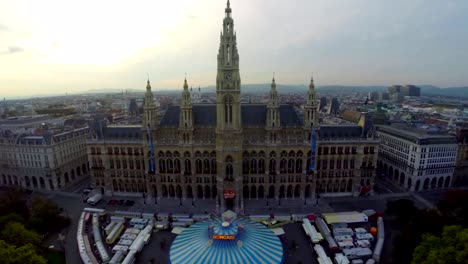 Rathaus-of-Vienna-aerial,-circus-underneath,-mayor-city-council.-Beautiful-aerial-shot-above-Europe,-culture-and-landscapes,-camera-pan-dolly-in-the-air.-Drone-flying-above-European-land.-Traveling-sightseeing,-tourist-views-of-Austria.
