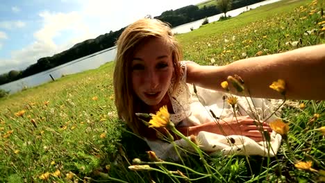 Young-female-takes-a-selfie-in-a-wildflower-meadow