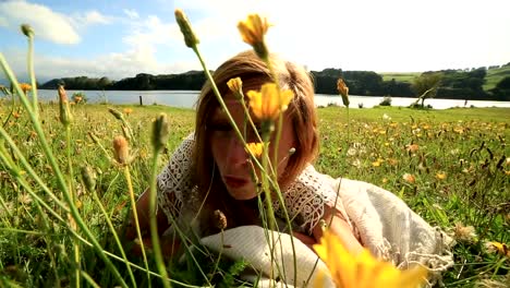 Young-female-takes-a-selfie-in-a-wildflower-meadow