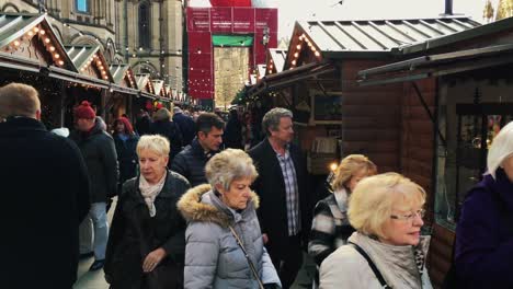 MANCHESTER,UK---DECEMBER-16,-2016.-Shot-of-shoppers-at-the-Christmas-market-in-front-of-the-Manchester-Town-Hall-on-Albert-Square.-December-16,-2016