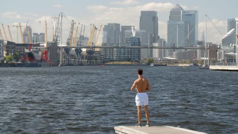 A-Very-fit-young-man-running-shirtless-though-London,-England's-Docklands.