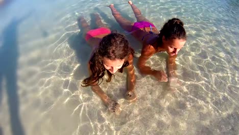 Portrait-smiling-girls-in-bikini-enjoying-being-alone-by-ocean-on-beach-vacation-shot