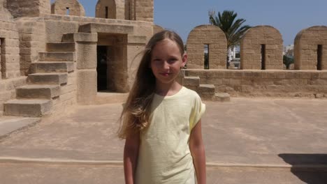 Young-girl-walking-outdoor-looking-to-camera