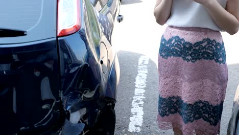 brunette-woman-stands-near-a-broken-car
