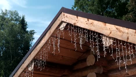 Garlands-on-the-roof-of-a-log-house.