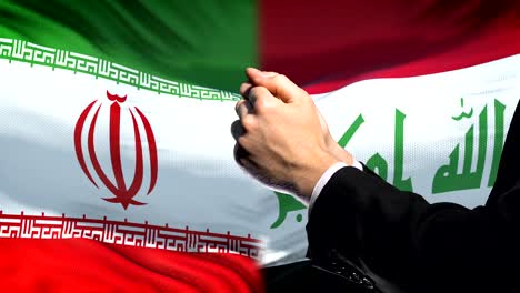 Iran-sanctions-Iraq,-chained-arms,-political-or-economic-conflict,-trade-ban