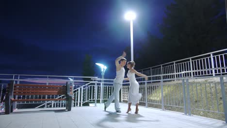 Couple-of-lovers-dancing-in-empty-night-street,-dating-and-love,-seduction