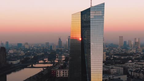 Frankfurt-ECB-Skyline-Aerial-Shot-at-early-sunrise-reflecting-sun