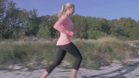 woman-jogging-along-the-sea-coast