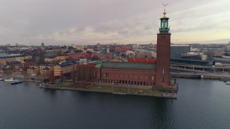 Stockholm-City-Hall-aerial-view.-Drone-shot-flying-around-Stockholm-Town-Hall,-famous-landmark-in-the-Capital-of-Sweden.-Nobel-Prize-building,-cityscape-in-the-background