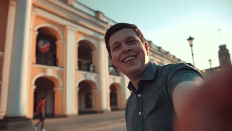 Happy-man-doing-selfies-on-smartphone-in-the-city